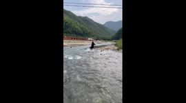 Man saves child from rushing water in east China