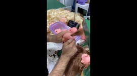 Doll Manufacturer Sews on Hair