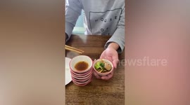 Customer slurps noodles from bizarre restaurant’s palm-sized bowl