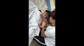 Heartwarming moment little boy kisses newborn sister for the very first time