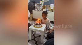 Family rush to save cake when excited birthday boy nearly topples it