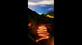 Thousands of torches light up mountain road in southwestern China