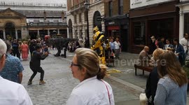 In Covent Garden in London, one street entertainer goes to the extreme by dressing as an awesome-looking mini Tyrannosaurus Rex dinosaur