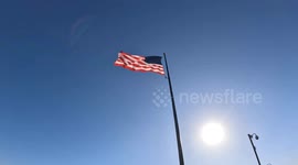 The Stars and Stripes moving the in the wind, against a blue sky