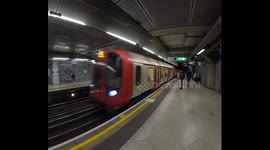 A London Underground train pulls into a Tube Station