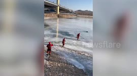 Firemen rescue grandfather who falls into icy lake in China