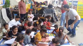 School Must Go on. A Volunteer takes classes of flood affected children