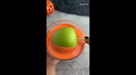 Woman has a fun way of decorating chocolate apple for the Halloween *Halloween Season Treats*