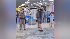 Tourist attacks police with a SKATEBOARD at notorious airport in Bangkok
