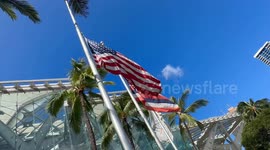 Shelter for Maui residents and tourists is Oahu Convention center | about 100 people, mostly tourists, found shelter at Hawaii Convention Center on Oahu | American and Hawaiian Flags on half mast in front of the convention center Oahu