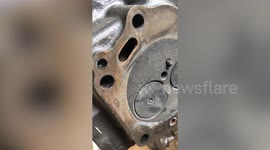 Mechanic fixing motorcycle finds beer bottle caps used in engine