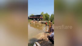 Cargo train transports dozens of pickup trucks for emerging economy Cambodia
