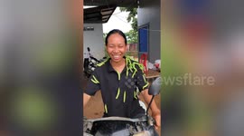 Dozens of green caterpillars cover woman riding on motorcycle
