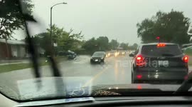 Torrential rain triggers flash flood chaos: cars navigate flooded Maitland Ave in Ottawa
