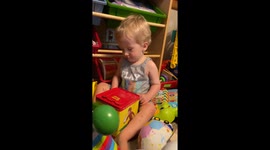 Adorable toddler is surprised by his Jack-in-the-box toy monkey *Wholesome Reaction*