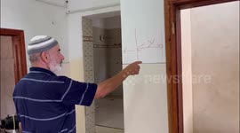 Family of Palestinian Khaled Sabah inspect their house after the Israeli forces raided in the West Bank city of Nablus.