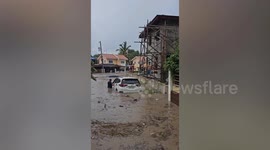 Residents tow car out of monsoon flood in the Philippines