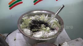 Watch how crispy pandan wafer rolls are freshly made at this street food stall in Bangkok