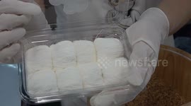 Confectioner shows how to make delicate 'Dragon's Beard' candy at street food stall in Thailand