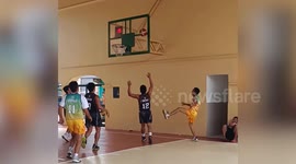 Basketball player leans on entranceway and falls thinking it is wall
