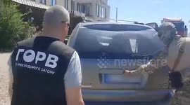 Ukrainian border guards discover two young Ukrainian men hiding under floor of car