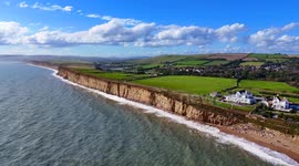The Jurassic Coast at Burton Bradstock in Dorset is bathed in warm sunshine as the skies clear after a morning of rain.