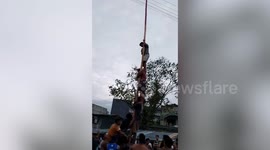Four injured when bamboo snaps during greasy pole-climbing game in the Philippines