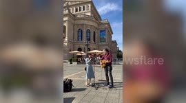 Tourist amazes passers-by when she joins busker in Germany to sing beautiful rendition of pop song