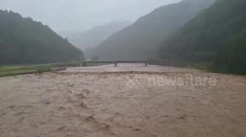 Japan: Rivers Swell As Typhoon Lan Brings Torrential Rain