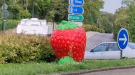 Giant strawberry in Paris suburb.  Roundabout in Jouy-en-Josas, France. 15 aug 2023