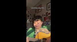 Adorable kitten sleeps on top of guitar while owner plays Coldplay cover