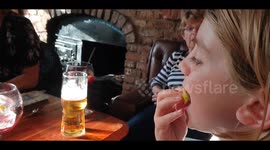 Charlie take a lemon from his drink and tries to suck the juice from it with a comedic mishap when the juice visibly shoots into his eye.