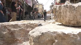 Palestinians inspect the damage following an Israeli military raid at the Balata refugee camp on the outskirts of Nablus in the West Bank early