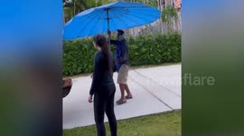 Street food seller's umbrella blown away by gust of wind