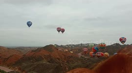 Hot Air Balloons Fly Over Colorful Danxia in Zhangye, China