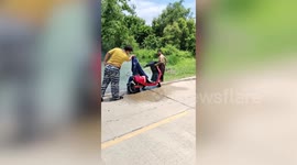 Electric motorcycle bursts into flames before passers-by extinguish fire