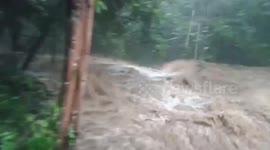 Flash flood surges over bridge at Thai national park