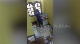 Monitor lizard caught behind family's desk