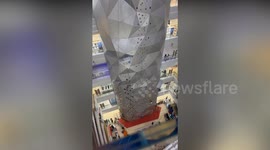 Fearless little girl effortlessly conquers 180ft high climbing wall