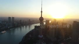 The UAV looks down and moves in parallel to photograph the surrounding environment of the Oriental Pearl TV Tower Radio and Television Tower in Shanghai.
