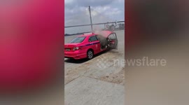 Taxi bursts into flames while boarding river-crossing ferry
