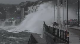 Holiday makers play in dangerous high tide waves as Storm Betty gives Penzance promenade a pummelling