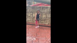 Roller Coaster Soaks Posing Bystander