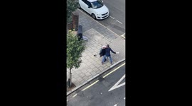 Two homeless people fight outside their homeless shelter (Cardinal Hume Centre, SW1P 2BG) on Arneway/Medway Street in Central London. Wrestling on the ground a bit before one of them gets punched in the face (audible) and then hits the ground with his bee