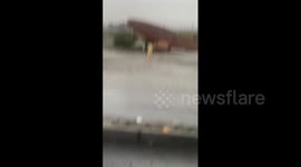 Palm Springs Airport sign tips on side as Tropical Storm Hillary strikes