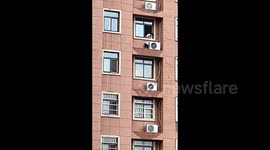 Terrifying moment boy scales high-rise apartment during hide-and-seek game in China