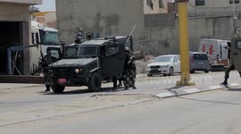 Israeli security forces block a road leading to the site of a reported attack south of Hebron in the West Bank.