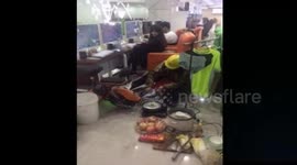 Man does housework in internet cafe while his wife plays computer games