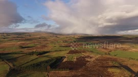 Drone footage of an isolated snow shower over the Northern Ireland countryside