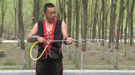 Martial artist uses his stomach to blow dart out and pop balloon behind glass